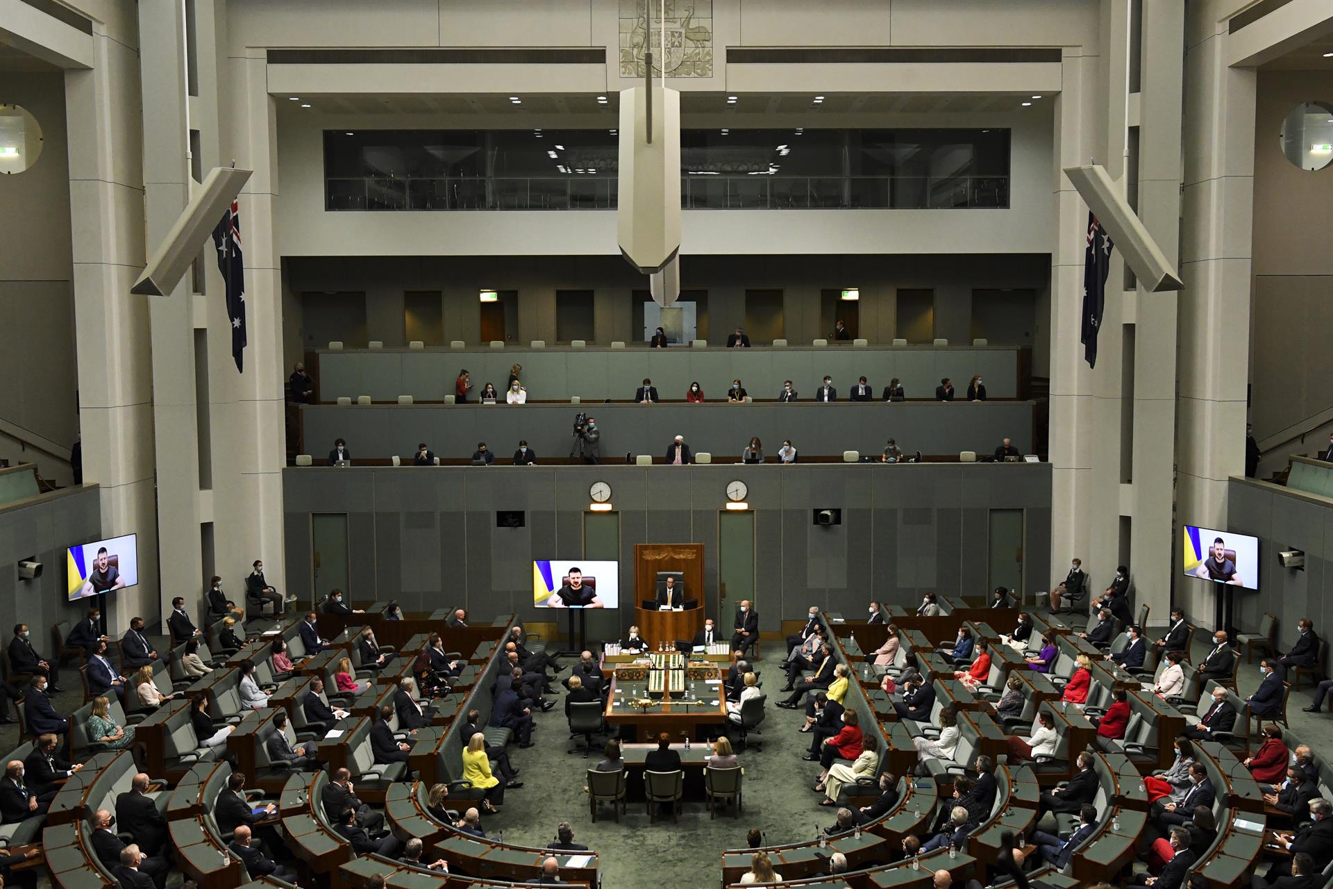 Un momento de la intervención por videoconferencia del presidente ucraniano, Volodimir Zelenski (en la pantalla) en el Parlamento australiano, en Canberra. EFE/EPA/LUKAS COCH
