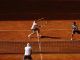 Los tenistas Carlos Alcaraz (i) y Marc López (d) durante su partido de dobles frente a la pareja formada por el polaco Lukasz Kubot y el francés Edouard Roger-Vasselin, en el Mutua Madrid Open disputado este domingo en la Caja Mágica, en Madrid. EFE/JUANJO MARTIN