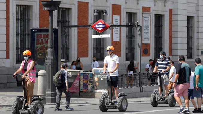 Varios turistas cruzan la Puerta del Sol de Madrid, en una fotografía de archivo. EFE/J.J. Guillén
