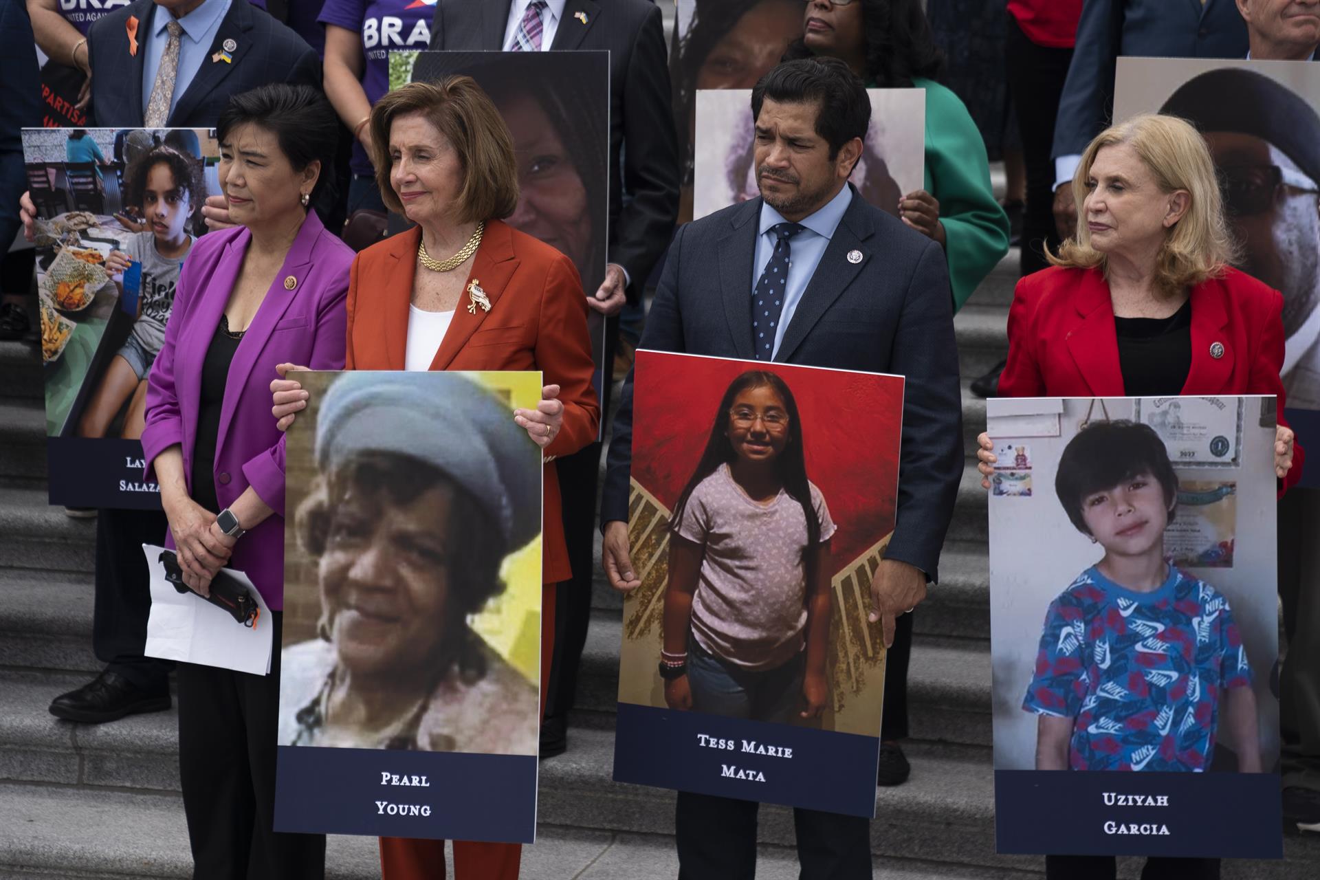 La presidenta de la Cámara Baja de EE.UU., Nancy Pelosi (2i), sostiene una fotografía de una víctima de la violencia armada en EE.UU., este 24 de junio de 2022, en Washington. EFE/Will Oliver
