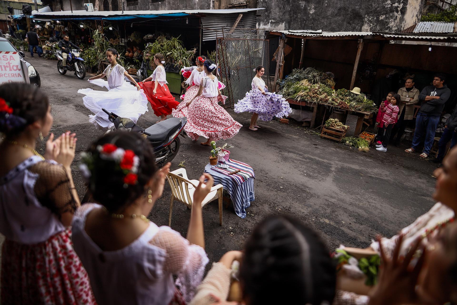 Un grupo de mujeres baila una danza típica paraguaya en el marco de la fiesta de San Juan, hoy, en el Mercado 4 en Asunción (Paraguay). EFE/ Nathalia Aguilar
