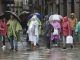 Turistas y peregrinos se protegen de la lluvia en Santiago de Compostela, este jueves. EFE/ Xoán Rey