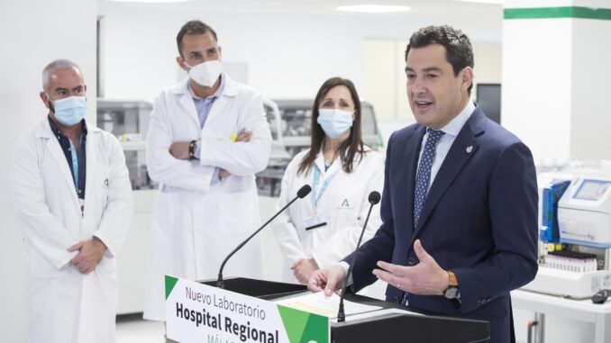 MÁLAGA, 21/03/2022.- El presidente de la Junta de Andalucía, Juanma Moreno (d), visita ell Servicio de Laboratorio del Materno Infantil de Málaga. EFE/Daniel Pérez
