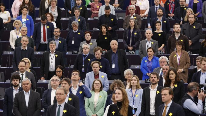 Miembros del Parlamento Europeo, con una flor amarilla en la solapa, guardan un minuto de silencio en recuerdo a las víctimas del levantamiento del gueto de Varsovia. EFE/EPA/JULIEN WARNAND
