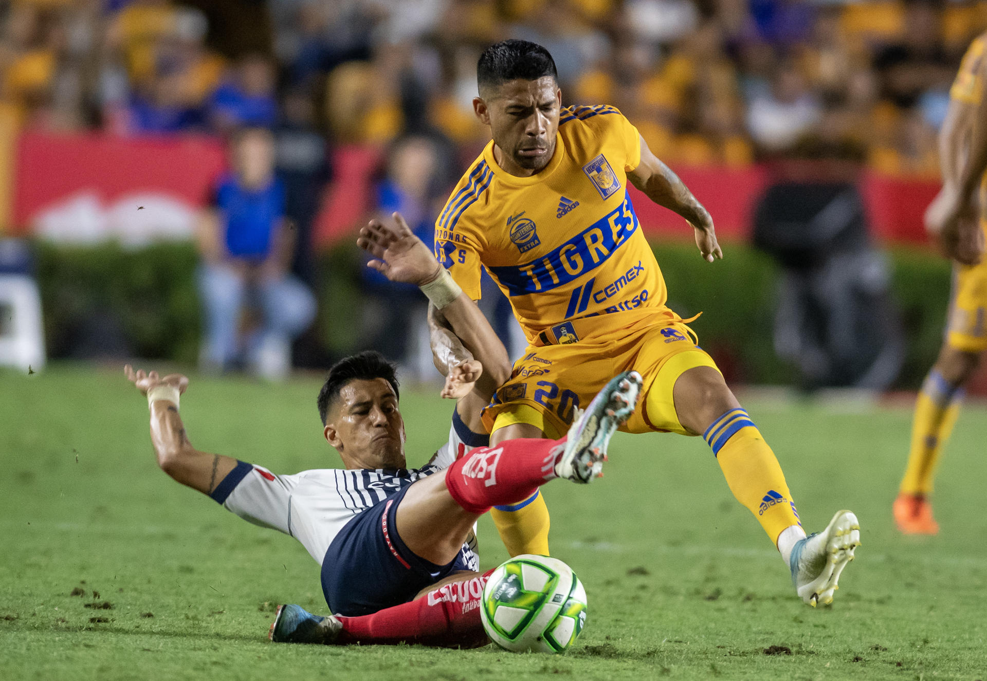 Javier Aquino (d) de Tigres disputa hoy el balón con Maximiliano Meza de Rayados, durante el partido de ida de la semifinal del torneo Clausura 2023, en el Estadio Universitario de Nuevo León, en Monterrey (México). EFE/Miguel Sierra
