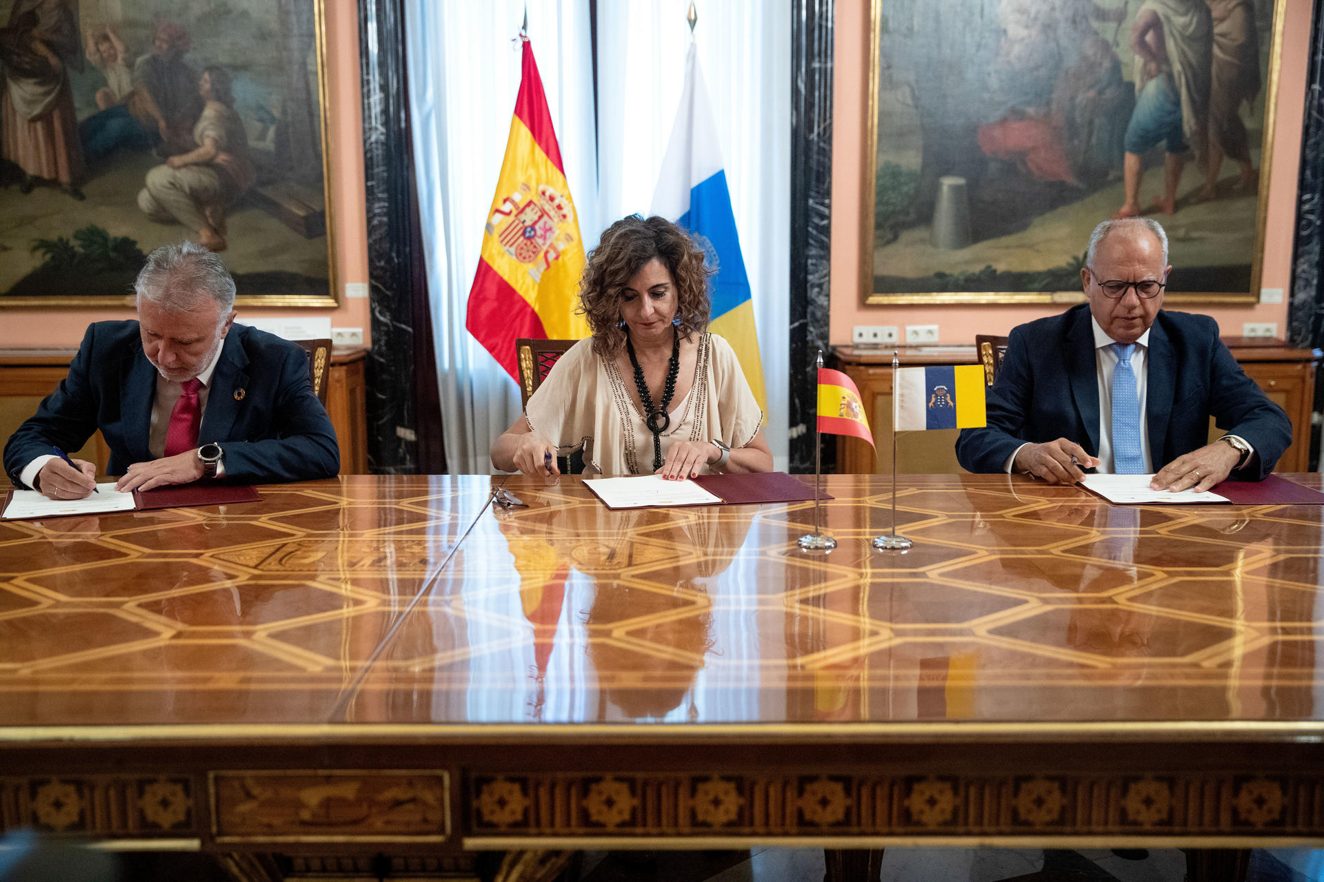 La ministra de Hacienda y Función Pública, María Jesús Montero, firma junto al presidente de Canarias, Ángel Víctor Torres (i), y el presidente del Cabildo de La Gomera, Casimiro Curbelo (d), un protocolo de colaboración para impulsar el plan estratégico 'Gomera 36', este miércoles en la sede del Ministerio. EFE/ J.P.Gandul
