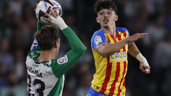 El delantero del Valencia, Diego López (d) trata de obstaculizar el saque de banda de Juan Miranda, del Betis, en el estadio Benito Villamarín, en Sevilla en una foto de la última jornada de la liga pasada de José Manuel Vidal. EFE
