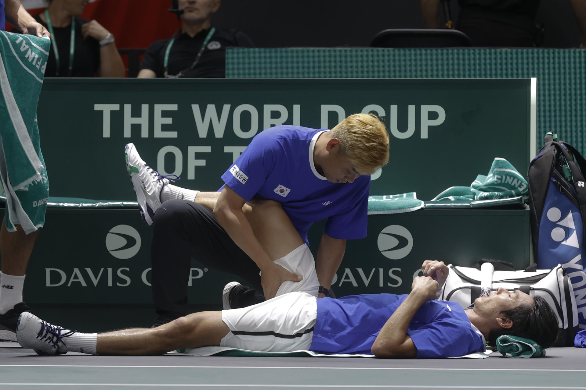 El jugador coreano Seongchan Hong,es atendido en pista durante su encuentro contra el checo Tomas Machac, durante el partido correspondiente al Grupo C del torneo de la Copa Davis que se juega en el Pabellón de la Fuente de San Luis de Valencia. EFE/ Kai Forsterling
