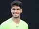 El tenista español Carlos Alcaraz de España en un partido benéfico contra el australiano Alex De Miñaur jugado antes del Abierto de Australia. EFE/EPA/JOEL CARRETT