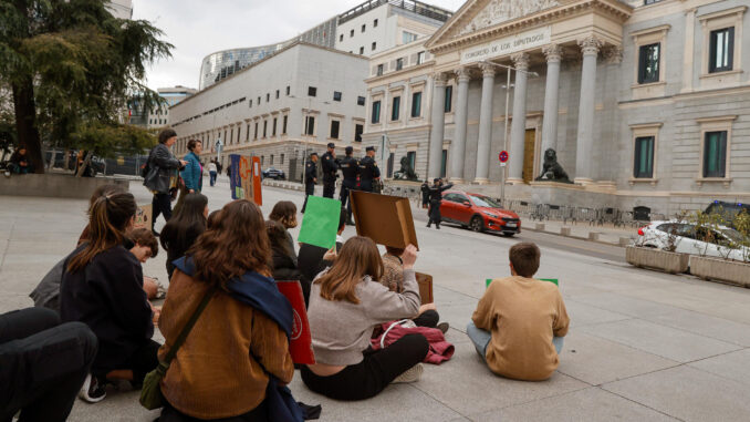 Jóvenes pertenecientes al movimiento 'Fridays for Future' se concentran frente al Congreso de los Diputados con motivo de la crisis climática, este viernes en Madrid. EFE/J P GANDUL
