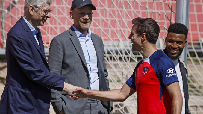 Los jugadores del Atlético de Madrid Thomas Lemar (d) y César Azpilicueta (2-d) saludan a Arsène Wenger (i), director de desarrollo de FIFA, y de Mattias Grafsröm (2-i), secretario general adjunto de fútbol de FIFA, durante el entrenamiento de este jueves en la Ciudad Deportiva Wanda en Majadahonda, Madrid. EFE/AtléticodeMadrid.com
