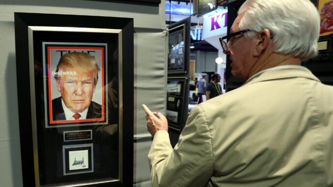 Foto de archivo de un hombre mirando una portada de Time con la foto de Donald Trump. EFE/Mike Nelson
