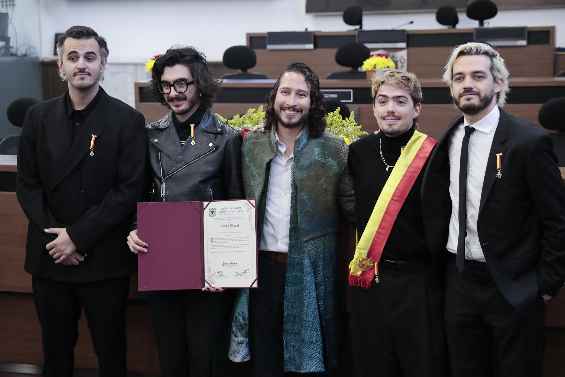 De izquierda a derecha,, los integrantes de la banda colombiana Morat, Juan Pablo Villamil, Juan Pablo Isaza, Simón Vargas, y Martín Vargas, posan junto al concejal de Bogotá Julián Sastoque (c) con un diploma en el Concejo de Bogotá, este lunes, en Bogotá (Colombia). EFE/ Carlos Ortega
