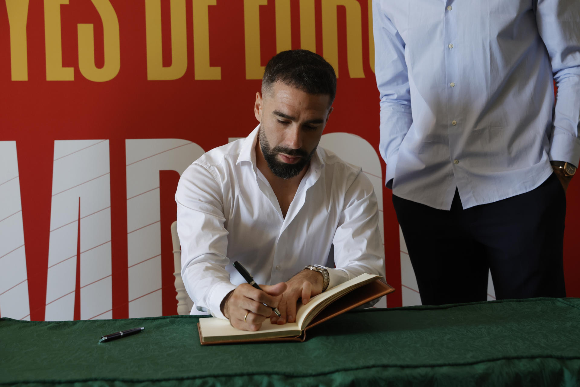 El jugador de la selección española de fútbol Dani Carvajal, vecino de Boadilla del Monte, firma en el libro de visitas del Ayuntamiento de Boadilla con motivo de su visita y la de su compañero Joselu para celebrar la reciente victoria del equipo en la Eurocopa. EFE/ Zipi
