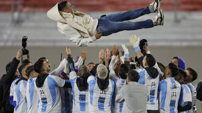 Jugadores de Argentina lanzan a Ángel di María (arriba) previo a un partido de las eliminatorias sudamericana para el Mundial 2026. EFE/ Juan Ignacio Roncoroni
