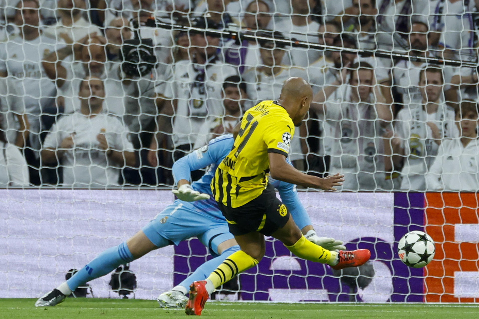 El delantero neerlandés del Borussia Donyell Malen anota el 0-1 durante el encuentro correspondiente a la fase regular de la Liga de Campeones entre Real Madrid y Borussia Dortmund, este martes en el estadio Santiago Bernabéu, en Madrid. EFE/ Juanjo Martin
