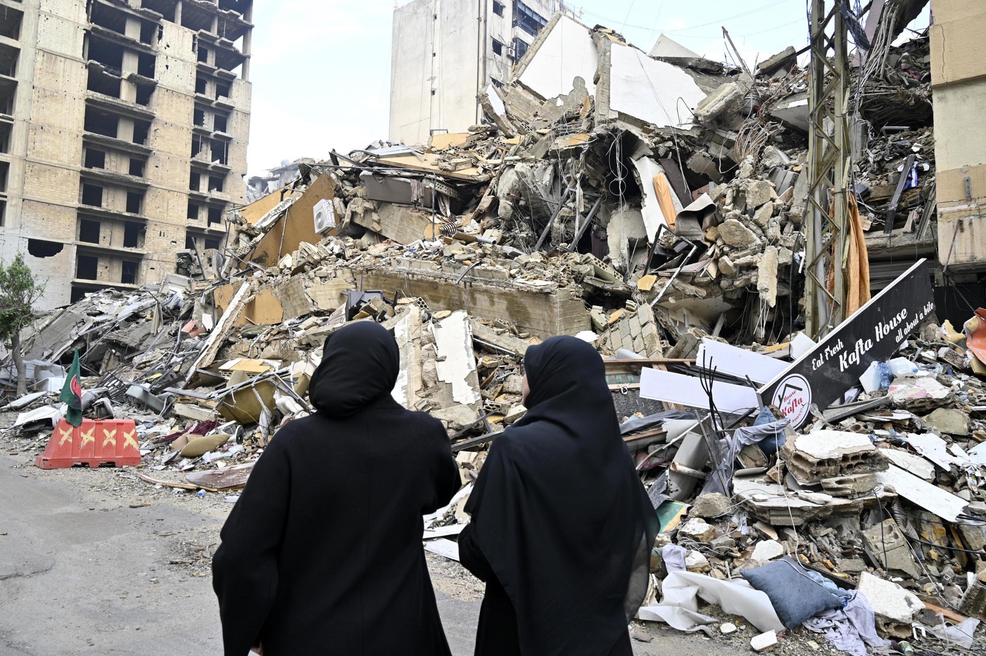 Mujeres libanesas miran un edificio dañado después de que entrara en vigor un alto el fuego con Israel, en el distrito de Dahye, en el sur de Beirut, Líbano, 27 de noviembre de 2024. 
EFE/EPA/WAEL HAMZEH
