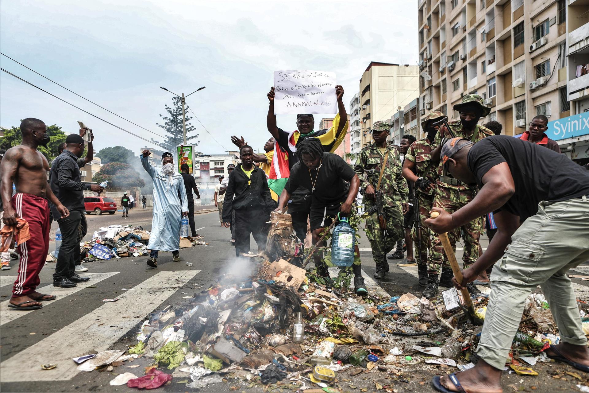 - Un manifestante sostiene un cartel que dice 'Si no hay justicia para el pueblo, no habrá paz para el gobierno' durante una protesta de seguidores del líder de la oposición Venancio Mondlane contra los resultados de las elecciones presidenciales en el centro de Maputo, Mozambique, 22 de noviembre de 2024. La policía mozambiqueña utilizó gas lacrimógeno para dispersar a cientos de manifestantes y simpatizantes del ex candidato presidencial Venancio Mondlane, quien se encuentra actualmente en el exilio, mientras cantaban el himno nacional de rodillas y desafiaban los resultados de las disputadas elecciones generales celebradas en octubre de 2024. (Elections, Protests) EFE/EPA/LUISA NHANTUMBO
