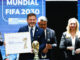 El presidente de la Conmebol, Alejandro Domínguez (i), junto a la secretaria general de la Presidencia de Argentina, Karina Milei (d) y el presidente de la Asociación del Fútbol Argentino (AFA), Claudio Tapia(atrás), participan durante un evento este miércoles, en Luque (Paraguay). Uruguay, Paraguay y Argentina fueron ratificados como parte de la sede de la Copa Mundial de la Fifa 2030, durante un congreso extraordinario realizado por los más de 200 socios de esa federación. EFE/ Juan Pablo Pino