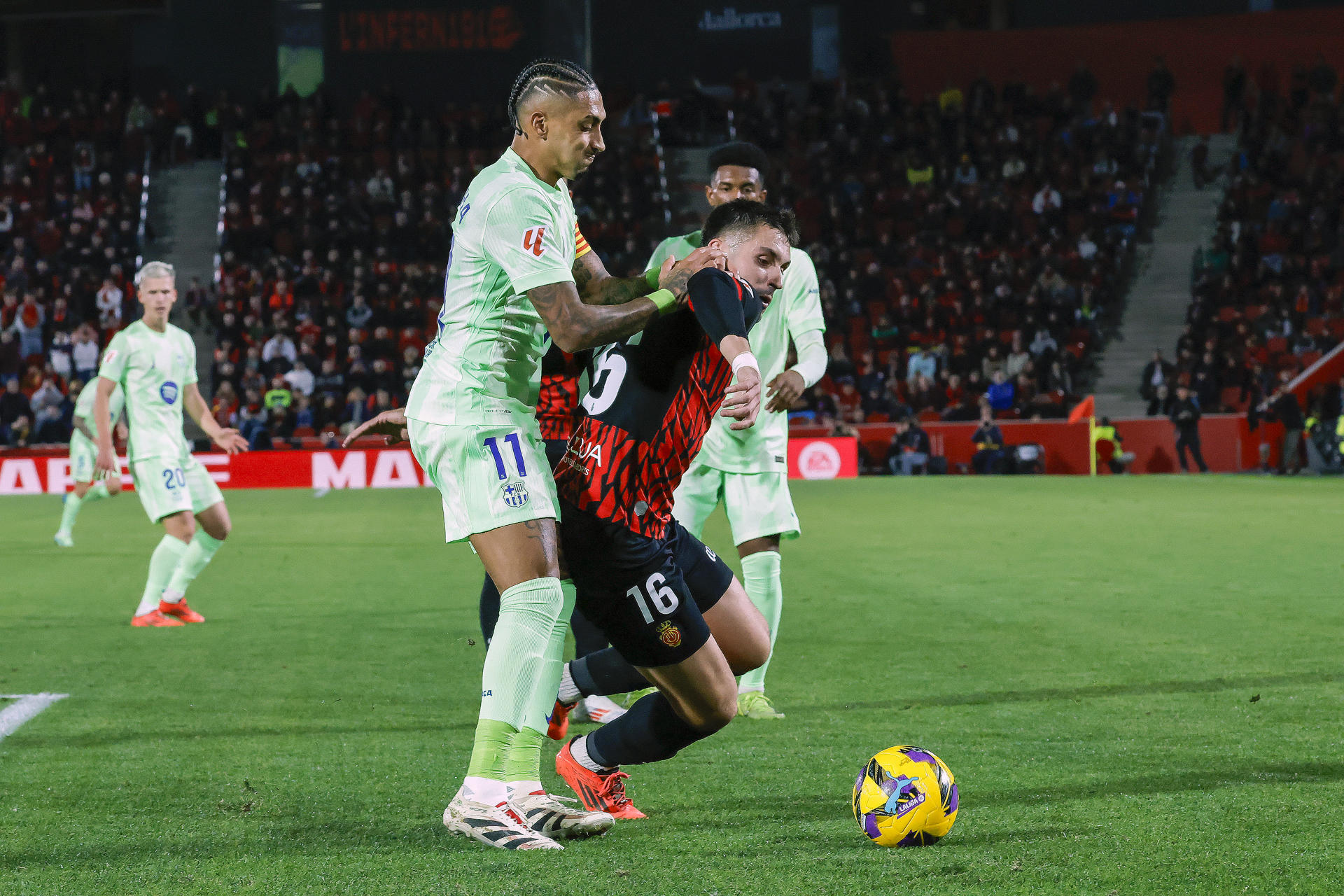 El centrocampista del Mallorca Valery Fernández (d) disputa un balón ante el delantero brasileño del Barcelona Raphinha durante el partido de LaLiga de la jornada 19en el estadio de Son Moix.- EFE/ Cati Cladera
