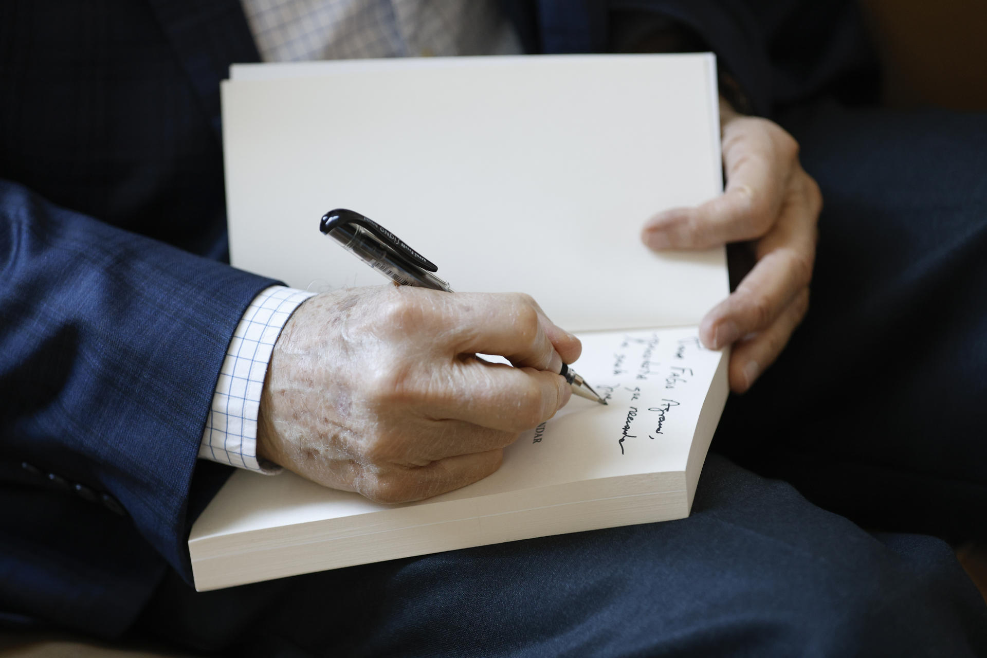 Fotografía del 13 de diciembre de 2024 del expresidente de Panamá (1978-1982) y ahora ministro para Asuntos del Canal de Panamá, Aristides Royo, firmando un libro durante una entrevista con EFE en Ciudad de Panamá (Panamá). EFE/ Bienvenido Velasco
