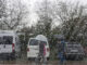 Varias personas caminan bajo la lluvia, este viernes, en la localidad cántabra de Santillana del Mar. EFE/Pedro Puente Hoyos