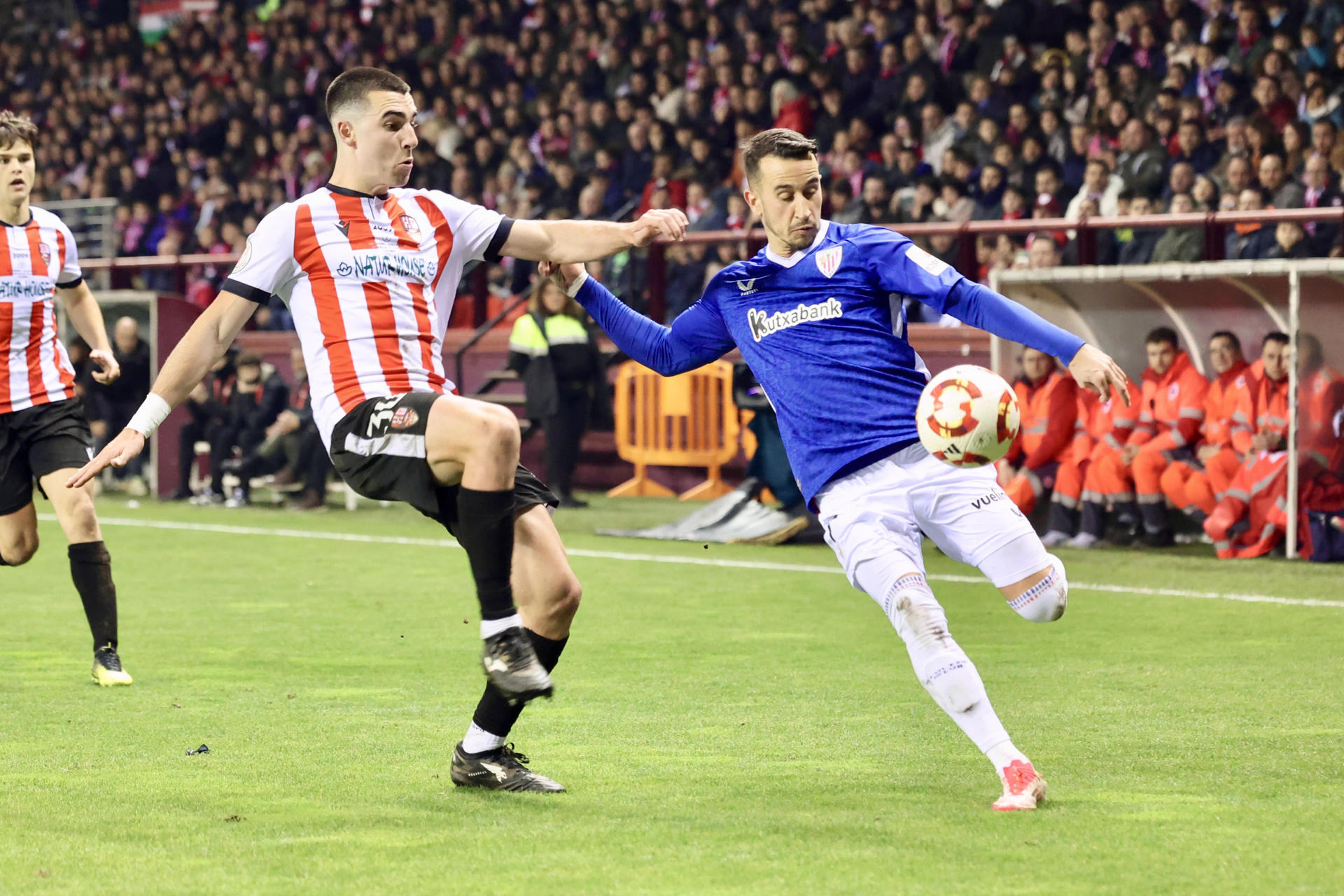 El delantero del Athletic Club, Alex Berenguer (d), disputa el balón ante el centrocampista del Logroñés, Iván Garrido, durante el partido de dieciseisavos de Copa del Rey que disputaron en el Estadio Las Gaunas de Logroño. EFE/ Raquel Manzanares.
