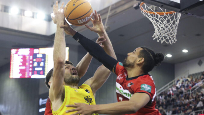 Tobey, del Gran Canaria, intenta anotar ante Clavell (d), del Granada, durante el partido de Liga Endesa disputado en el Palacio de los Deportes de Granada. EFE/Pepe Torres
