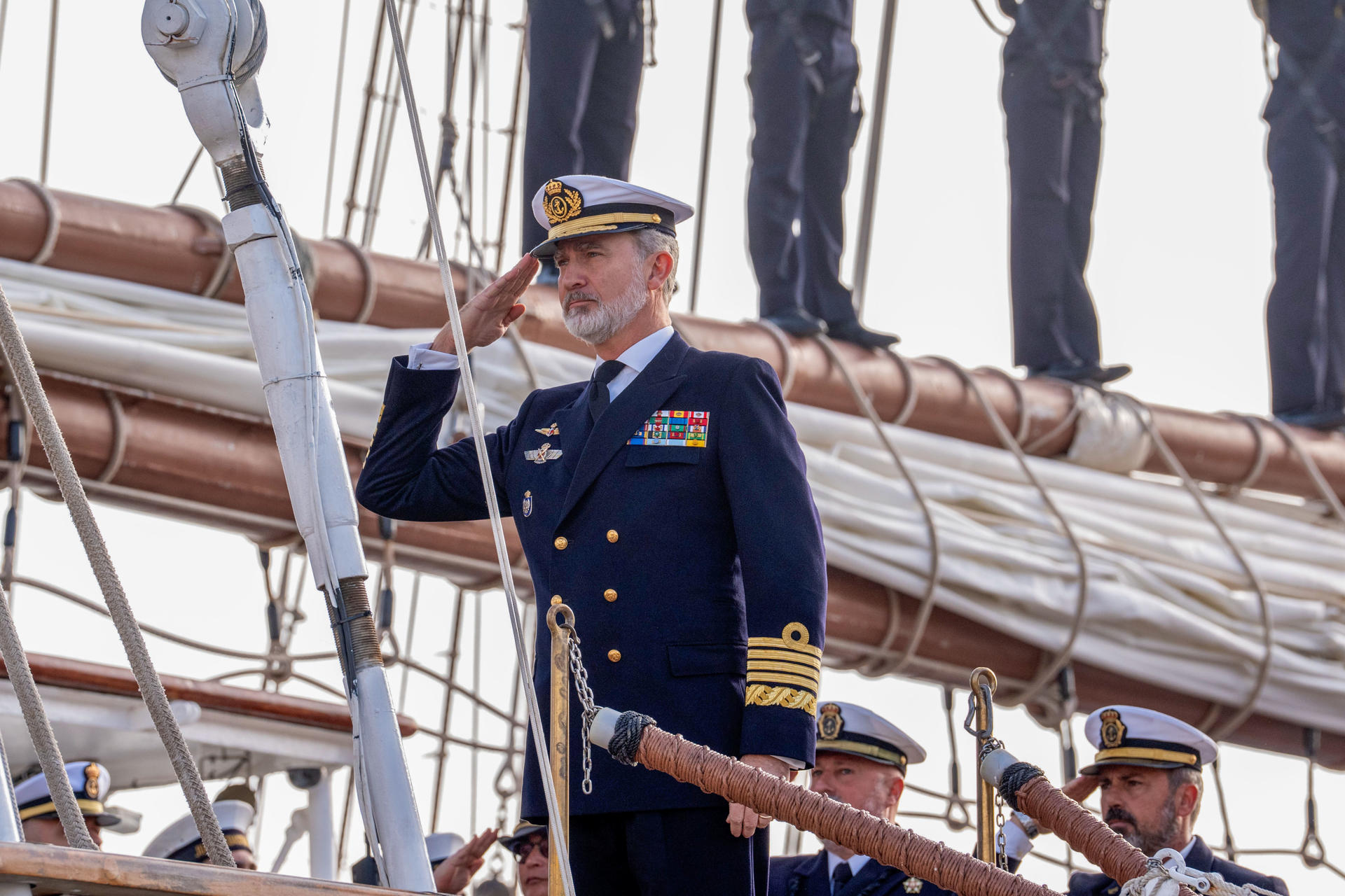 El rey Felipe saluda militarmente a bordo del buque escuela de la Armada española Juan Sebastián de Elcano en Cádiz, donde se despidió de la princesa de Asturias, Leonor, que parte este sábado en esta embarcación para iniciar la travesía del 97 crucero de instrucción. EFE/ Román Ríos
