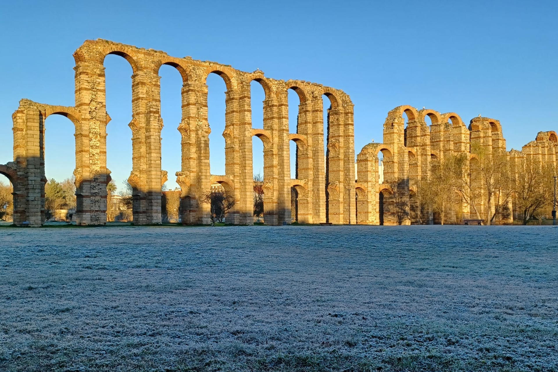 Vista del Acueducto de Los Milagros de Mérida este martes, cuyo entorno ha amanecido cubierto de hielo, tras una madrugada en la que muchas zonas de Extremadura han tenido heladas generalizadas y temperaturas de hasta -4 grados. EFE/ Pablo Caro
