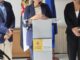 Ministra Milagros Tolón durante el anuncio del Plan Psicosocial de Apoyo para la educación en Ceuta, logotipo del Gobierno de España y Delegación del Gobierno en Ceuta